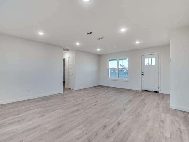 interior space featuring recessed lighting, baseboards, visible vents, and light wood finished floors