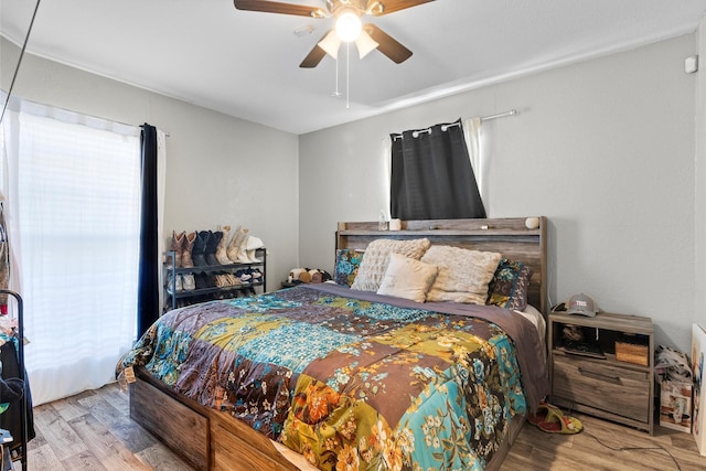 bedroom with ceiling fan and light hardwood / wood-style floors