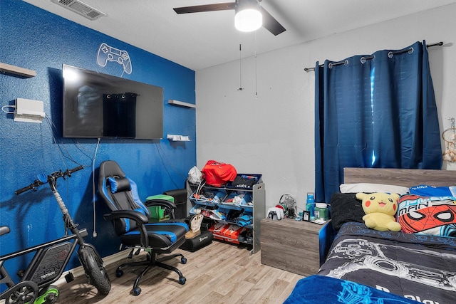 bedroom featuring hardwood / wood-style floors and ceiling fan