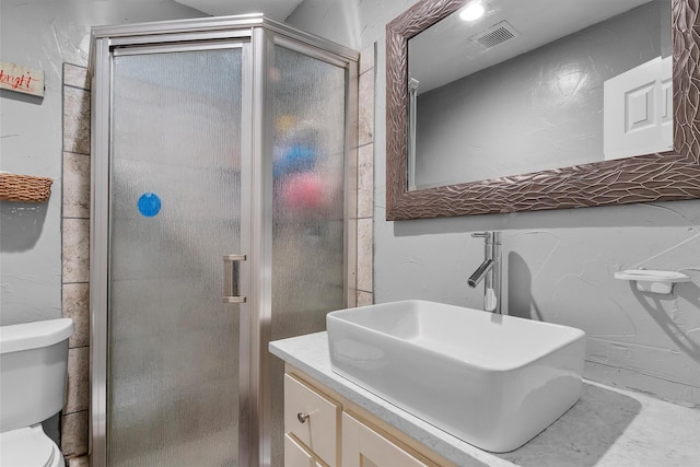 bathroom with vanity, an enclosed shower, and toilet