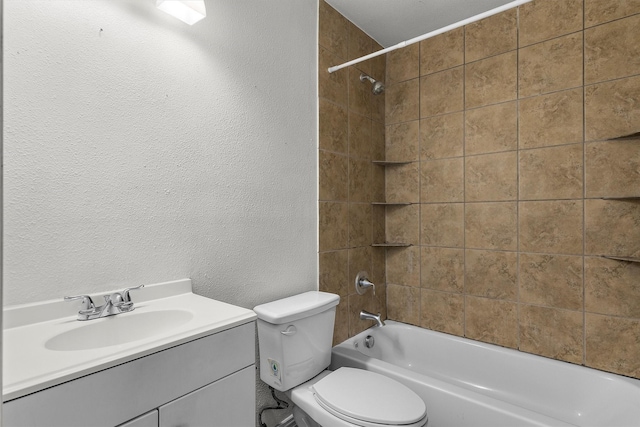 full bathroom with vanity, tiled shower / bath combo, and toilet