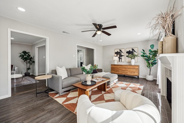 living room with visible vents, baseboards, dark wood-style flooring, and recessed lighting