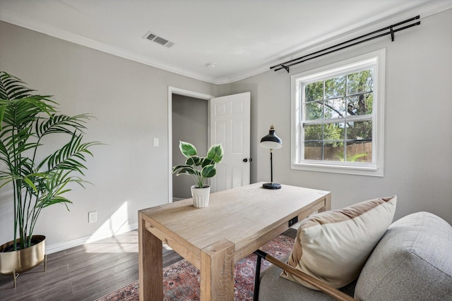 office featuring ornamental molding, wood finished floors, visible vents, and baseboards