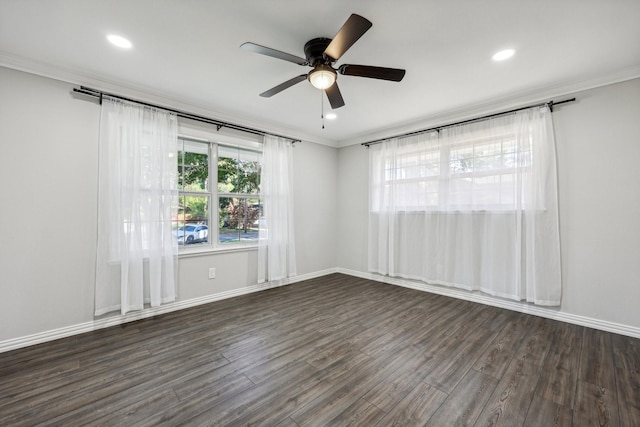 empty room featuring plenty of natural light, ornamental molding, and wood finished floors