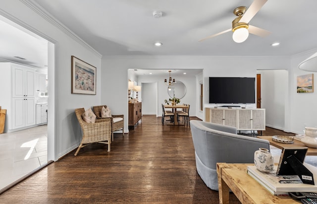 living room featuring crown molding, ceiling fan, and dark hardwood / wood-style flooring