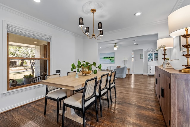 dining room featuring dark hardwood / wood-style flooring, ceiling fan with notable chandelier, and ornamental molding