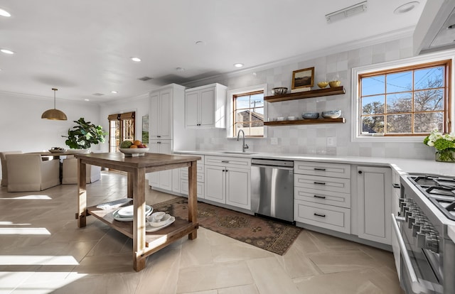 kitchen featuring sink, decorative light fixtures, stainless steel appliances, and white cabinets