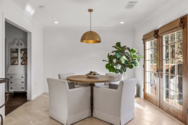 dining area with ornamental molding, light tile patterned flooring, and french doors