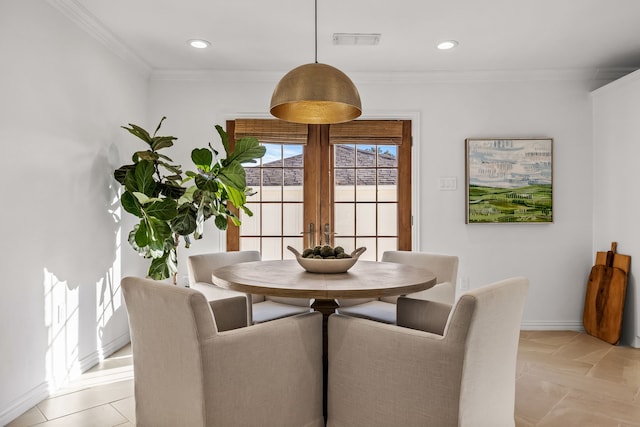 dining room with crown molding and french doors