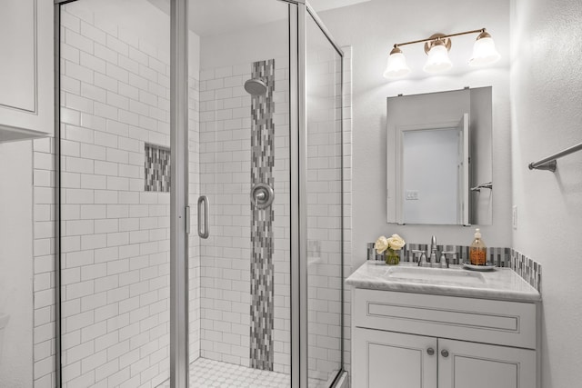 bathroom featuring vanity and a shower with shower door