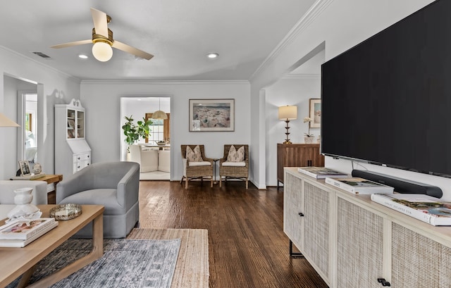 living room featuring dark wood-type flooring, ceiling fan, and ornamental molding