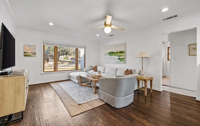 living room featuring dark wood-type flooring, ceiling fan, and crown molding