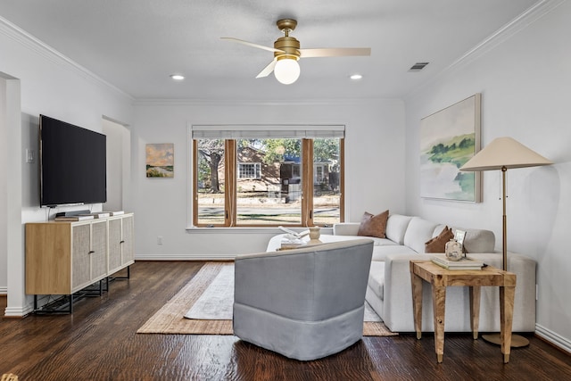 living room with dark wood-type flooring, ornamental molding, and ceiling fan