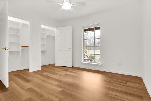 unfurnished bedroom with wood finished floors, a ceiling fan, and baseboards