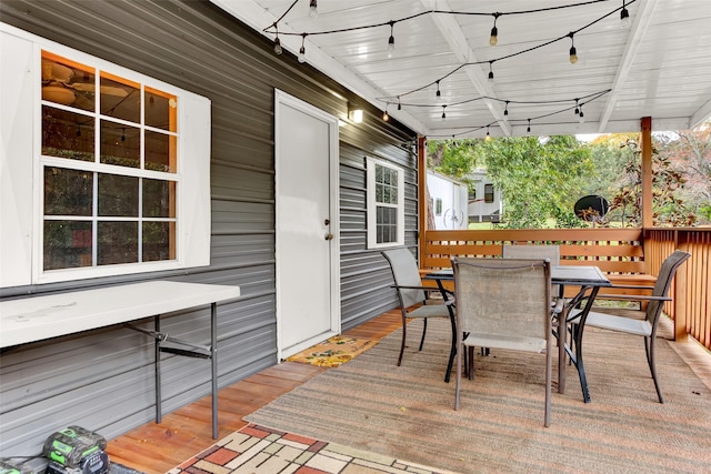 wooden terrace featuring outdoor dining space