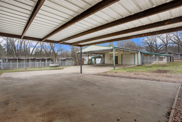 view of patio featuring a carport and fence