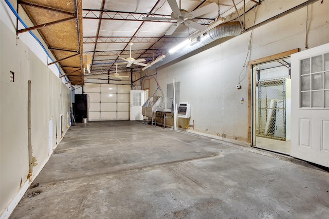 garage featuring ceiling fan and heating unit