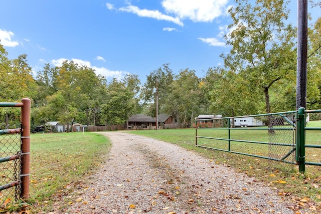 exterior space with a gated entry, gravel driveway, and a gate