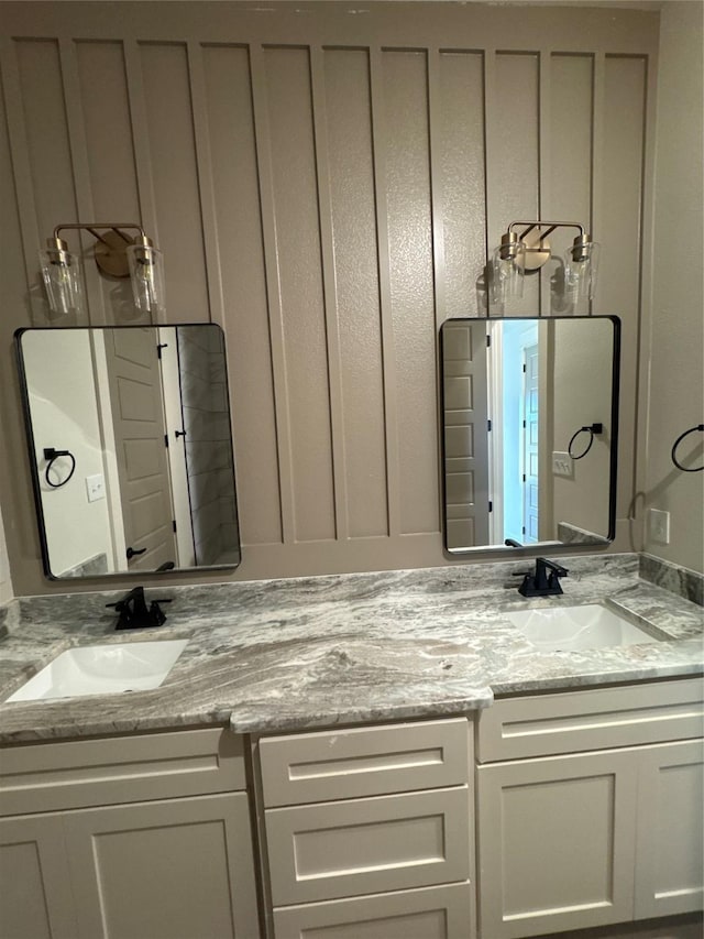 bathroom with a sink and double vanity