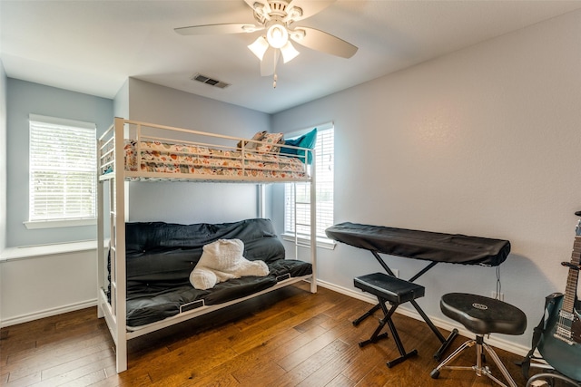 bedroom with ceiling fan and dark hardwood / wood-style flooring