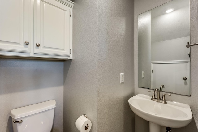 bathroom with sink and toilet