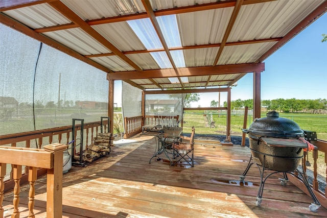 wooden deck with area for grilling and a rural view