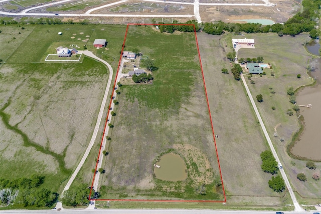 birds eye view of property featuring a water view and a rural view