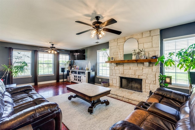 living room with ceiling fan, dark wood-type flooring, and a fireplace