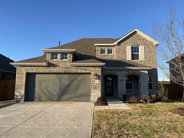 view of front of property featuring an attached garage, brick siding, fence, driveway, and roof with shingles