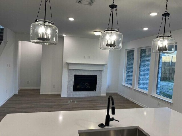 kitchen with pendant lighting and dark wood-type flooring