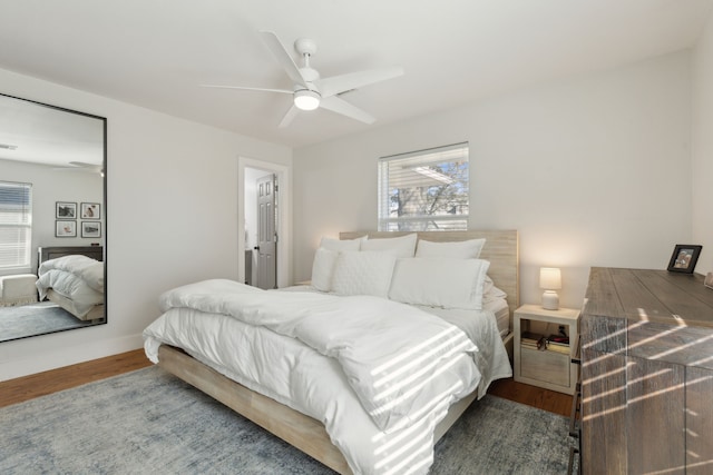 bedroom featuring multiple windows, wood-type flooring, and ceiling fan