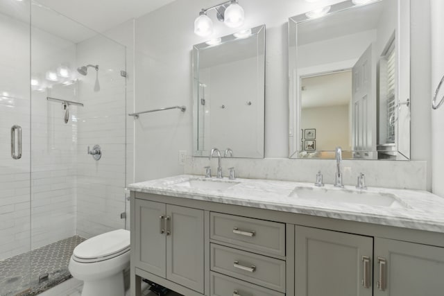 bathroom with vanity, toilet, and an enclosed shower