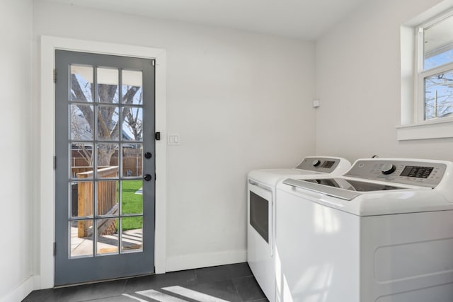 laundry room featuring dark tile patterned floors and separate washer and dryer