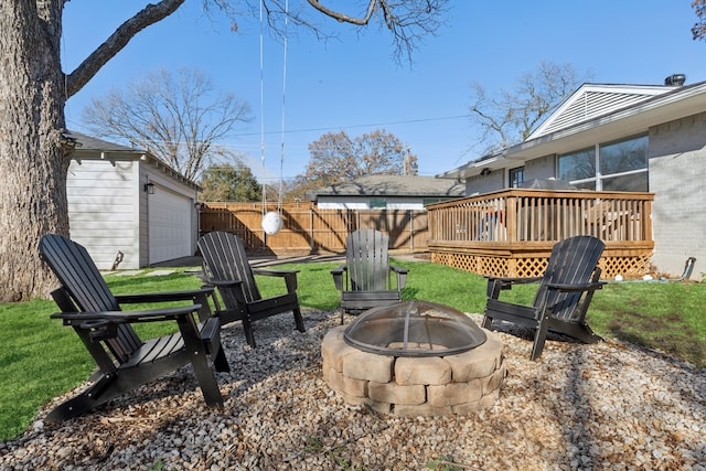 exterior space featuring an outdoor fire pit, a deck, and a storage unit