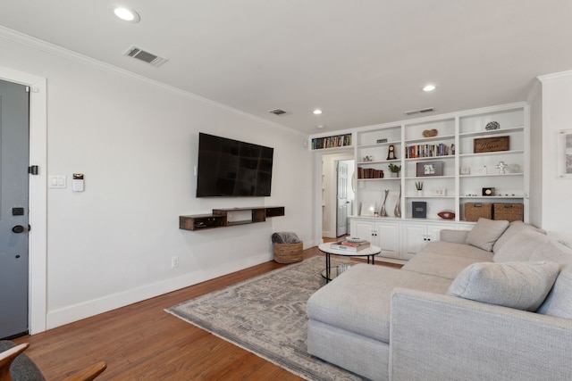 living room featuring crown molding and hardwood / wood-style floors