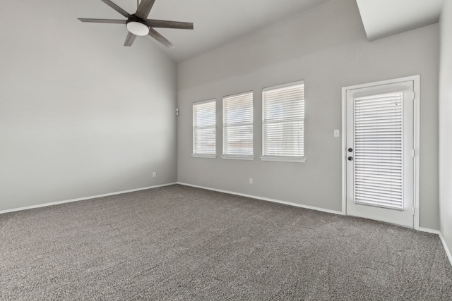 spare room featuring lofted ceiling, ceiling fan, and carpet flooring