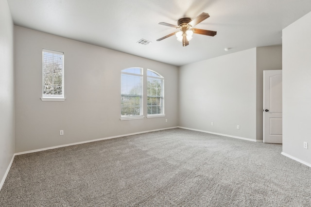 spare room with carpet floors and ceiling fan