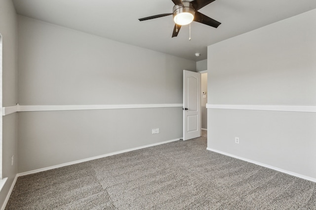 empty room with ceiling fan and carpet floors