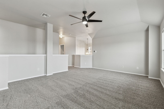 unfurnished room with vaulted ceiling, ceiling fan, and carpet