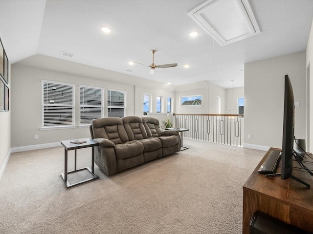 living room featuring light carpet, vaulted ceiling, and ceiling fan