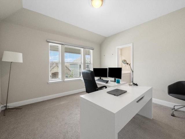 home office featuring vaulted ceiling and light carpet