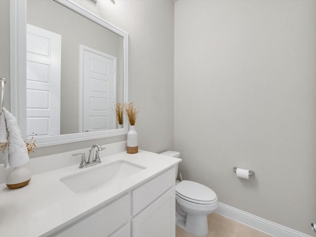 bathroom with vanity, tile patterned floors, and toilet