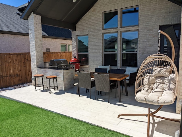 view of patio with area for grilling, grilling area, and exterior bar