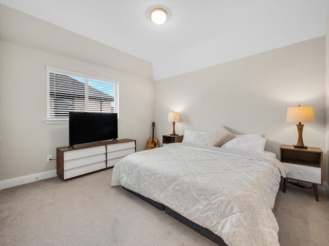 carpeted bedroom featuring lofted ceiling