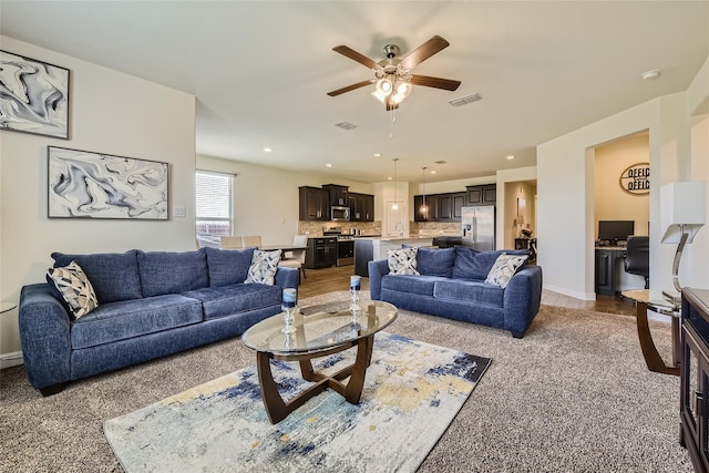 living room with sink and ceiling fan