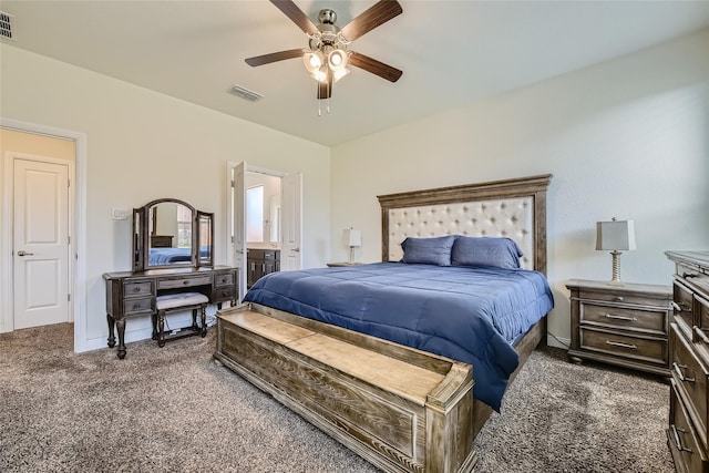 carpeted bedroom featuring ceiling fan and ensuite bath