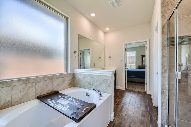 bathroom featuring hardwood / wood-style floors and shower with separate bathtub