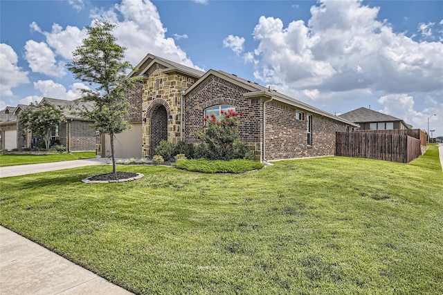 view of front of property with a garage and a front lawn