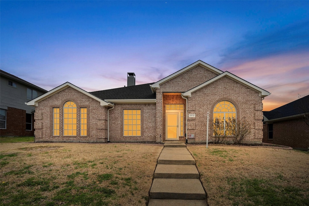 ranch-style house with a lawn