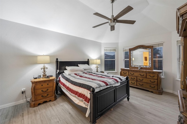 bedroom with vaulted ceiling, ceiling fan, and light hardwood / wood-style flooring